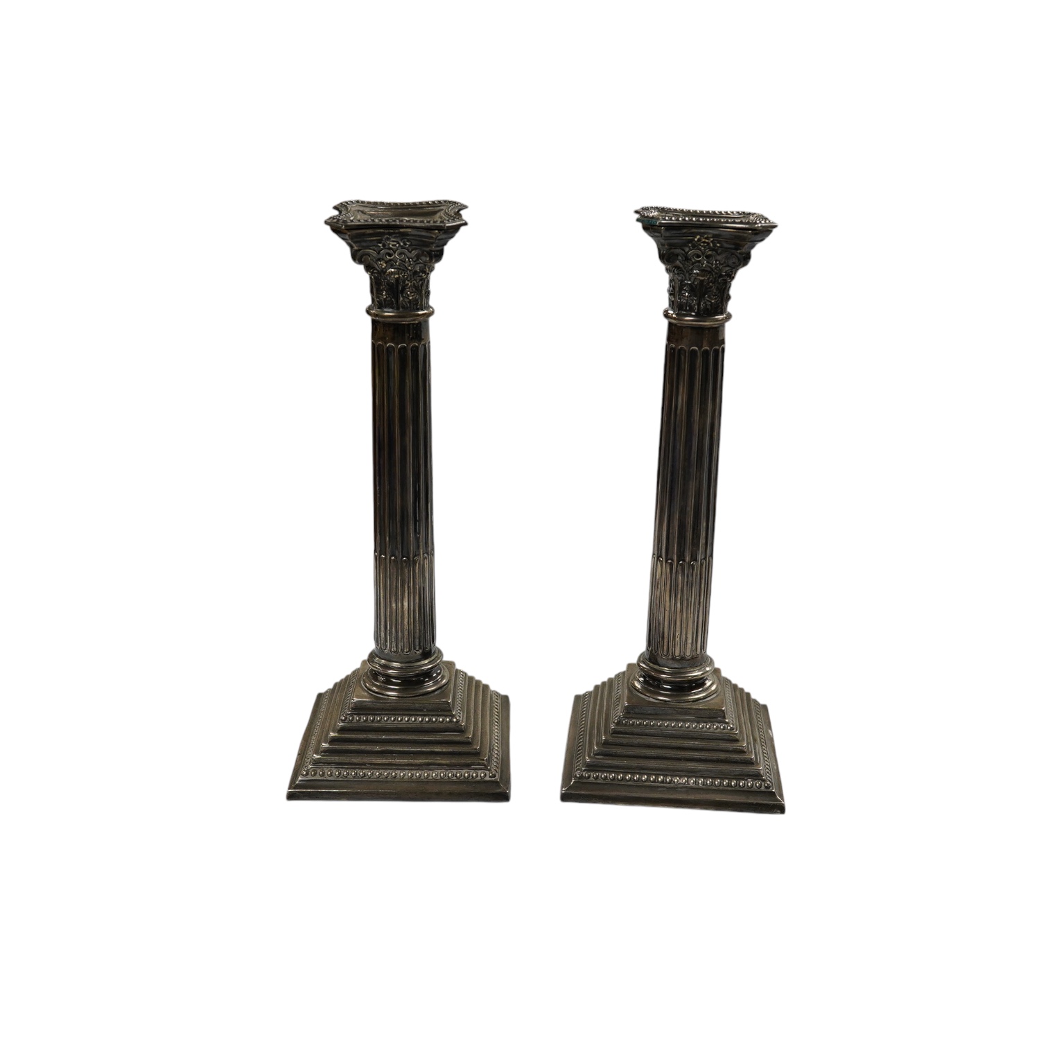 A pair of Elizabeth II silver Corinthian column candlesticks, Alexander Smith, Birmingham, 1972, sconces unmarked, 25.7cm, weighted. Condition - fair